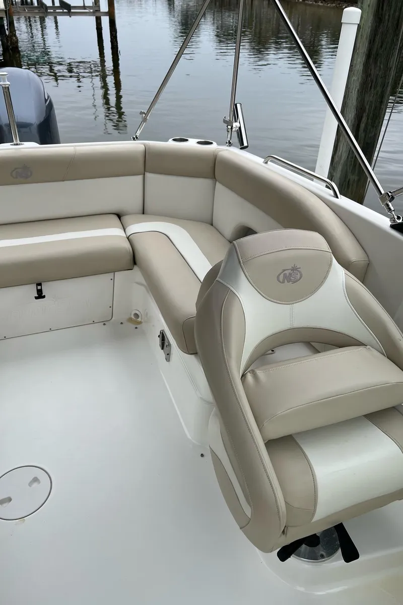 Slide: The Image of 2017 NauticStar 243DC Sport Deck boat interior with beige seating. - 14