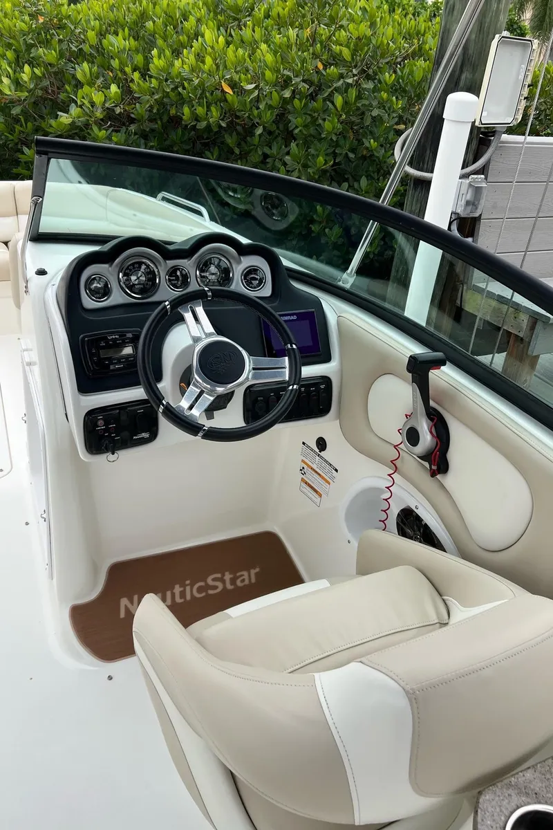 Slide: The Image of 2017 NauticStar 243DC Sport Deck boat cockpit with steering wheel and dashboard. - 15