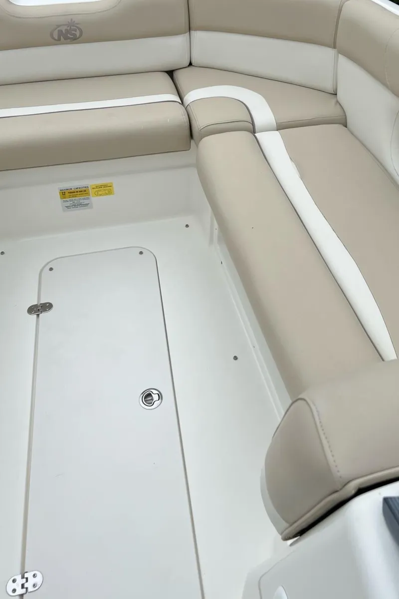 Slide: The Image of 2017 NauticStar 243DC Sport Deck interior seating and storage compartment. - 17