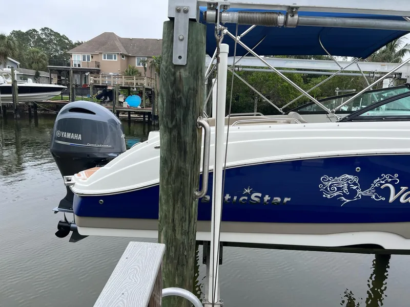 Slide: The Image of 2017 NauticStar 243DC Sport Deck boat docked with Yamaha outboard motor. - 2