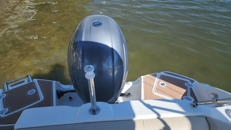Slide: The Image of 2017 NauticStar 243DC Sport Deck boat engine and deck view. - 24