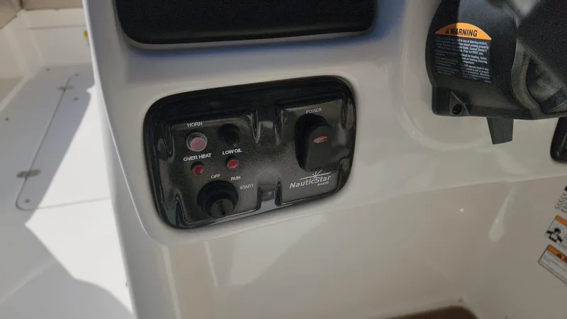 Slide: The Image of Control panel of a 2017 NauticStar 243DC Sport Deck boat. - 26
