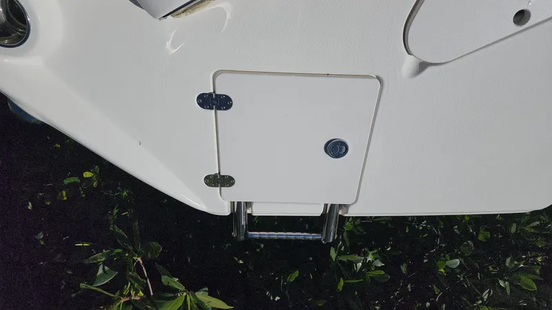 Slide: The Image of 2017 NauticStar 243DC Sport Deck boat ladder compartment. - 33