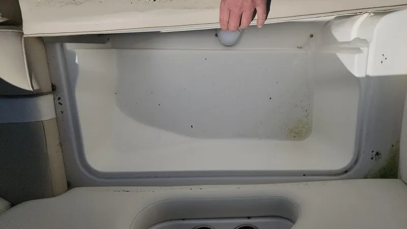 Slide: The Image of 2017 NauticStar 243DC Sport Deck storage compartment with hand opening lid. - 36