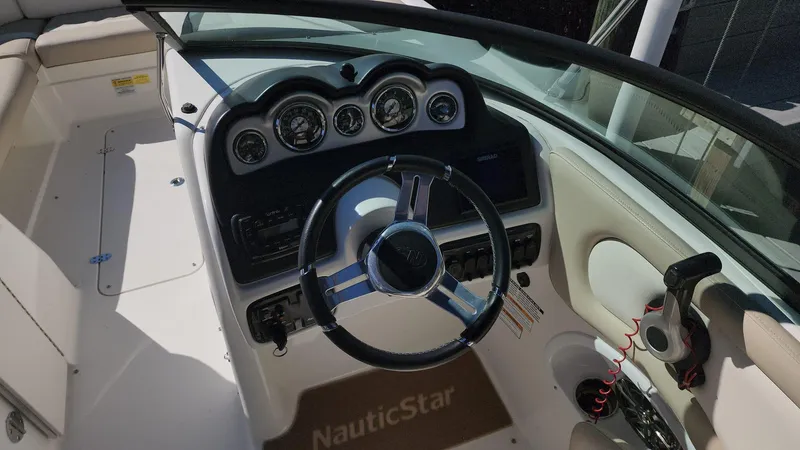 Slide: The Image of 2017 NauticStar 243DC Sport Deck boat dashboard and steering wheel. - 4