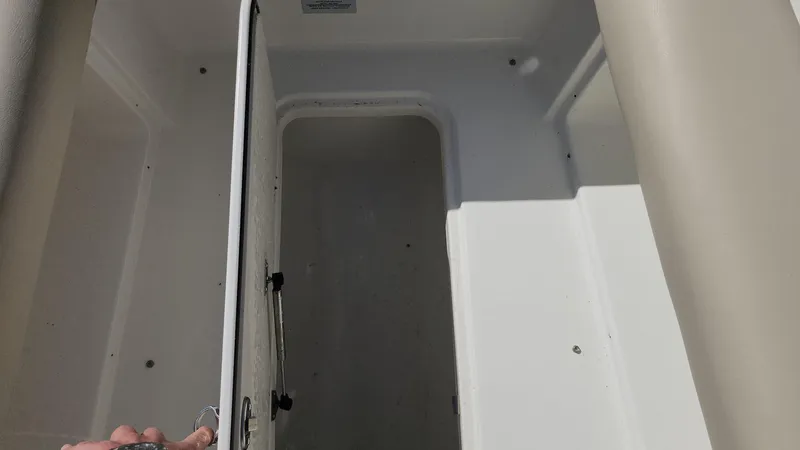 Slide: The Image of 2017 NauticStar 243DC Sport Deck storage compartment interior. - 40