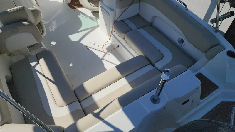 Slide: The Image of 2017 NauticStar 243DC Sport Deck interior seating area with beige and white upholstery. - 41