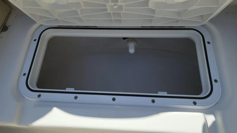 Slide: The Image of Open storage compartment on a 2017 NauticStar 243DC Sport Deck boat. - 43