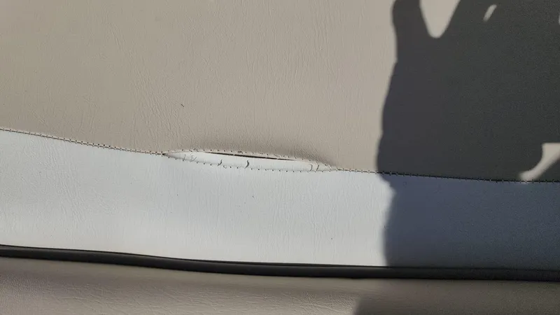 Slide: The Image of Close-up of damaged upholstery on a 2017 NauticStar 243DC Sport Deck boat. - 44