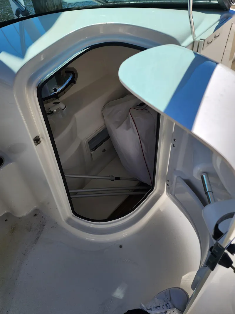 Slide: The Image of 2017 NauticStar 243DC Sport Deck storage compartment. - 46