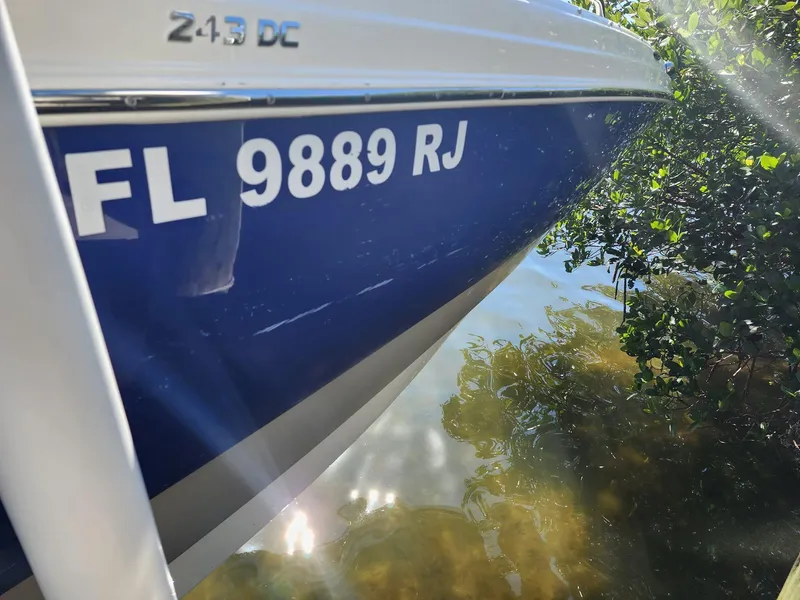Slide: The Image of 2017 NauticStar 243DC Sport Deck boat on water with registration number FL 9889 RJ. - 47