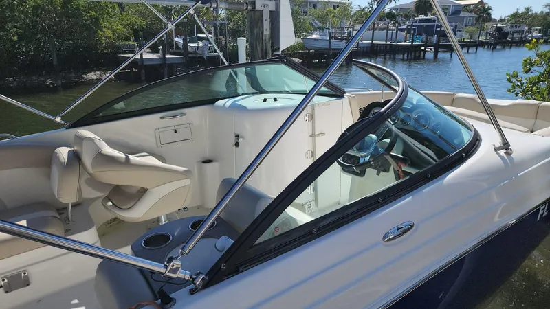 Slide: The Image of 2017 NauticStar 243DC Sport Deck boat interior with seating and steering wheel. - 7