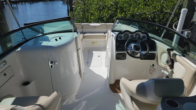 Slide: The Image of 2017 NauticStar 243DC Sport Deck boat interior with steering console and seating. - 8