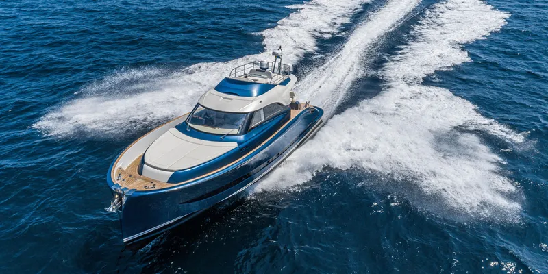 Slide: The Image of 2024 Solaris Power 48 Flybridge yacht cruising on open water. - 2