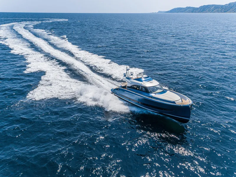 Slide: The Image of 2024 Solaris Power 48 Flybridge yacht cruising on open sea. - 4