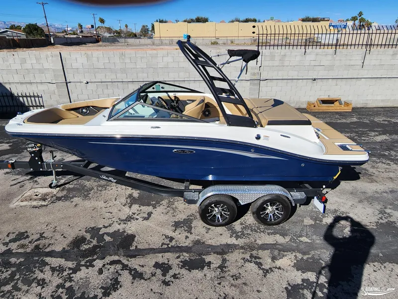 Slide: The Image of 2023 Sea Ray SPX 190 boat on trailer, parked outdoors. - 0