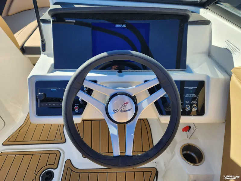 Slide: The Image of 2023 Sea Ray SPX 190 boat dashboard with steering wheel and control panel. - 11