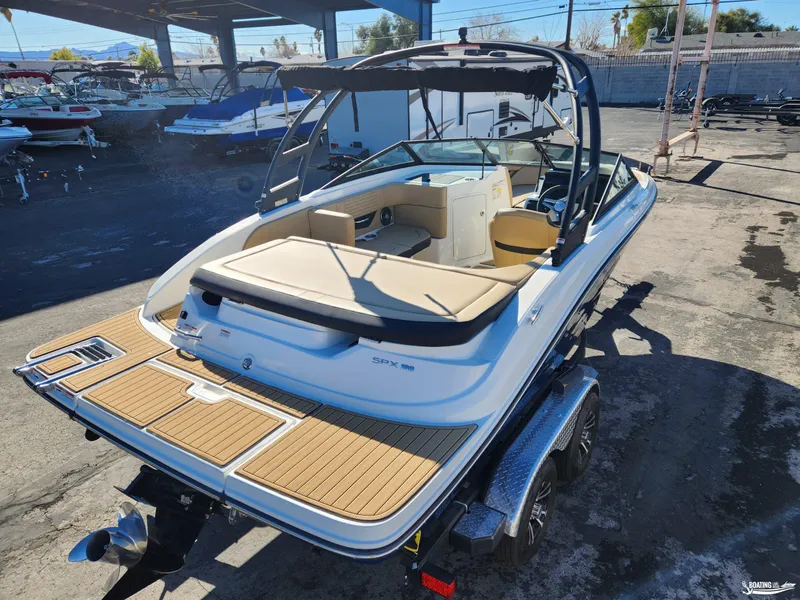 Slide: The Image of 2023 Sea Ray SPX 190 boat on trailer, featuring sleek design and spacious seating. - 4