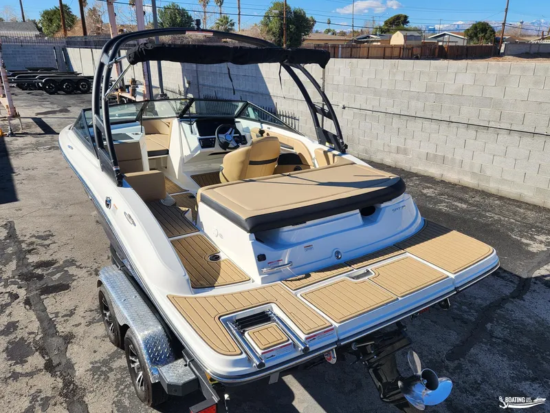 Slide: The Image of 2023 Sea Ray SPX 190 boat with tan interior and sleek design on a trailer. - 5