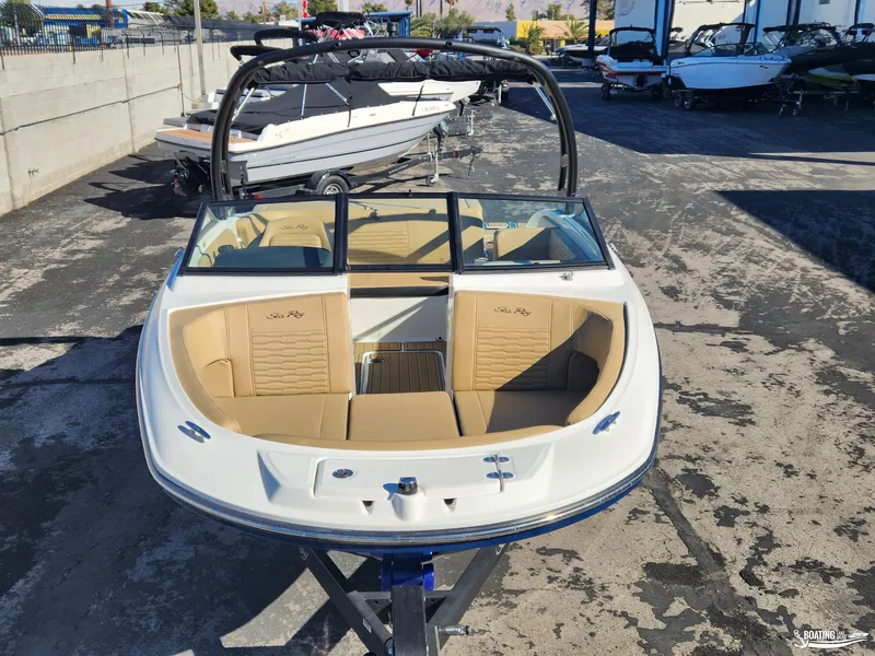 Slide: The Image of 2023 Sea Ray SPX 190 boat with tan interior on display outdoors. - 6
