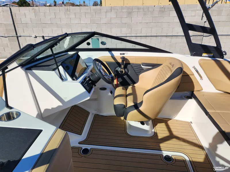 Slide: The Image of 2023 Sea Ray SPX 190 boat interior with tan seating and modern dashboard. - 8