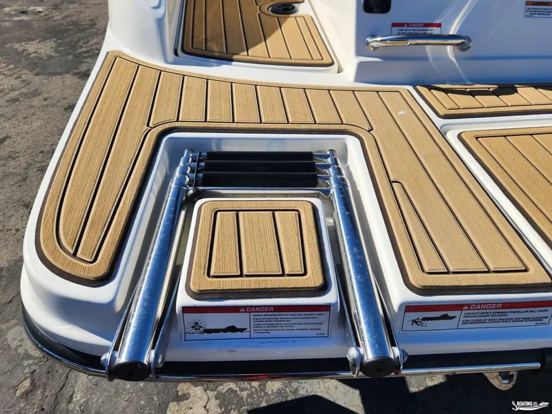Slide: The Image of 2023 Sea Ray SPX 190 swim platform with teak-style decking and retractable ladder. - 9