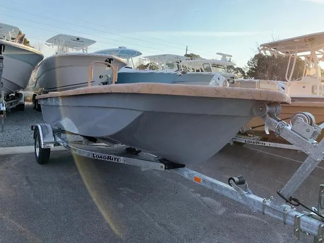 The Image of 2022 Rabco 16' Bucaneer boat on LoadRite trailer in a marina. - 1