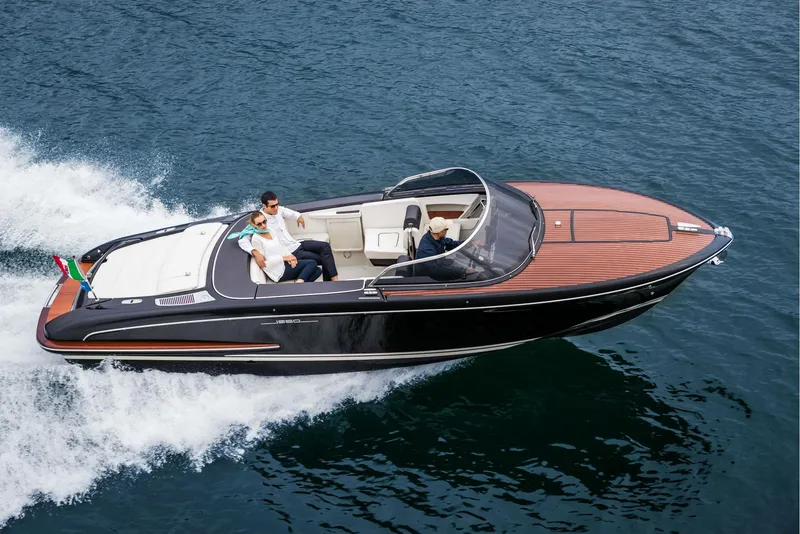 Slide: The Image of 2025 Riva Iseo luxury speedboat cruising on open water. - 2