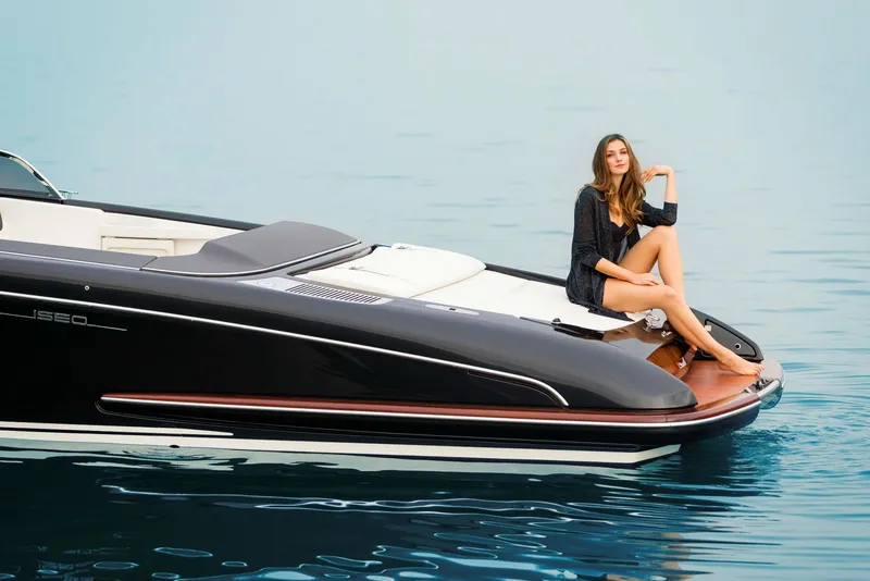 Slide: The Image of Woman relaxing on a 2025 Riva Iseo luxury boat on calm water. - 8