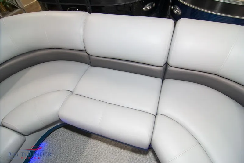 Slide: The Image of 2022 Manitou 25 Oasis SR SHP boat interior seating with gray and white upholstery. - 13