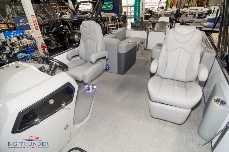 Slide: The Image of 2022 Manitou 25 Oasis SR SHP interior with luxurious seating and modern dashboard. - 17