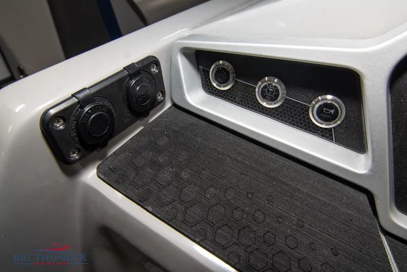 Slide: The Image of Control panel of 2022 Manitou 25 Oasis SR SHP boat with switches and outlets. - 22