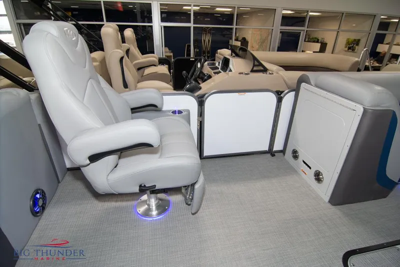 Slide: The Image of 2022 Manitou 25 Oasis SR SHP boat interior with luxurious seating and modern design. - 31