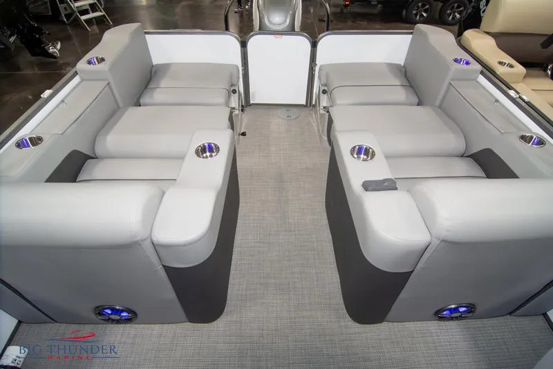 Slide: The Image of 2022 Manitou 25 Oasis SR SHP pontoon boat interior with plush seating and cup holders. - 35