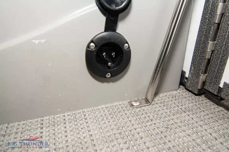 Slide: The Image of 2022 Manitou 25 Oasis SR SHP boat interior detail with electrical outlet. - 41