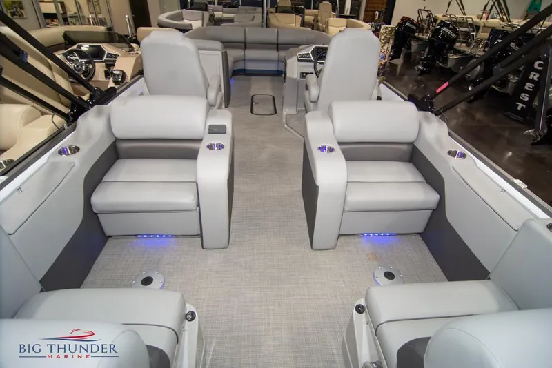 Slide: The Image of 2022 Manitou 25 Oasis SR SHP pontoon boat interior with plush seating and LED lighting. - 42