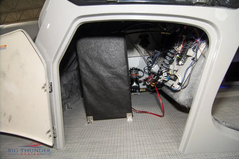 Slide: The Image of 2022 Manitou 25 Oasis SR SHP storage compartment with wiring and equipment. - 46