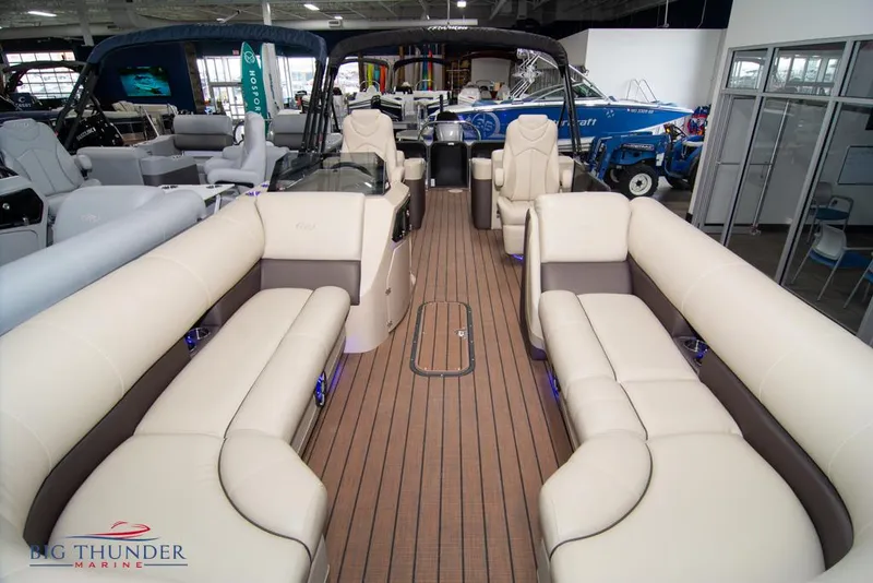 Slide: The Image of 2022 Manitou 25 Oasis SR SHP pontoon boat interior with luxurious seating. - 10