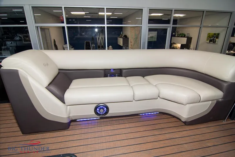 Slide: The Image of 2022 Manitou 25 Oasis SR SHP boat interior with luxurious seating and LED lighting. - 11