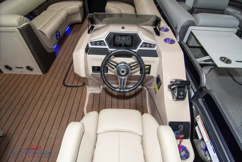 Slide: The Image of 2022 Manitou 25 Oasis SR SHP boat cockpit with modern steering wheel and dashboard. - 17
