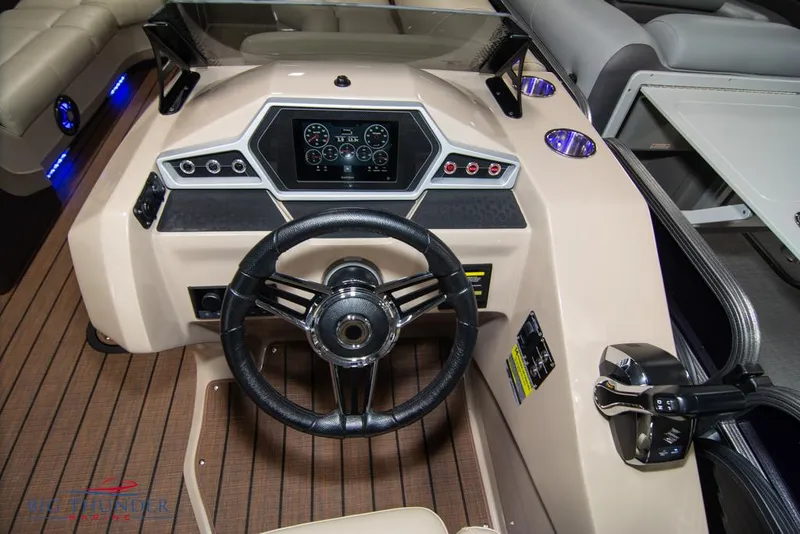 Slide: The Image of 2022 Manitou 25 Oasis SR SHP boat dashboard with steering wheel and control panel. - 18