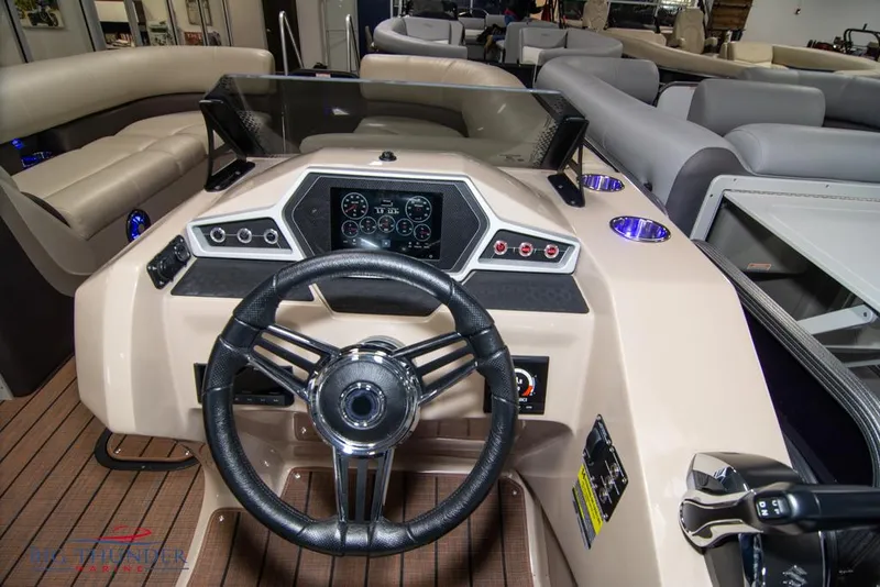 Slide: The Image of 2022 Manitou 25 Oasis SR SHP boat dashboard with steering wheel and control panel. - 19