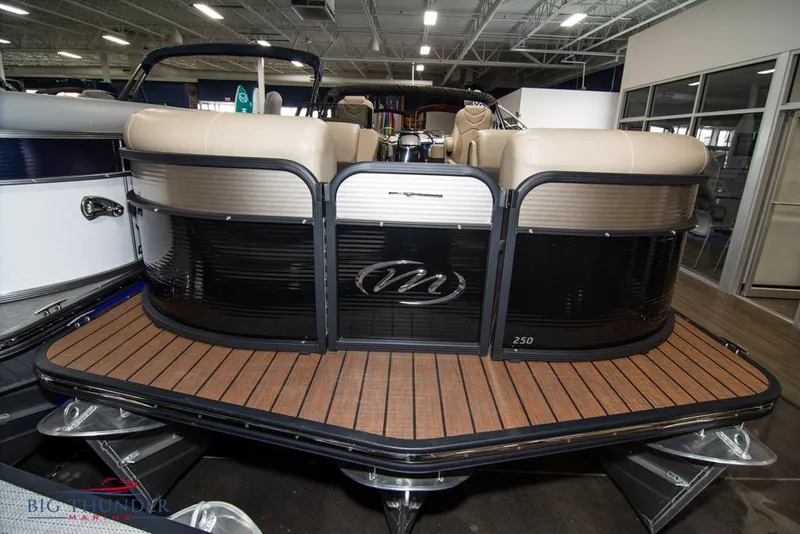 Slide: The Image of 2022 Manitou 25 Oasis SR SHP pontoon boat in showroom. - 2