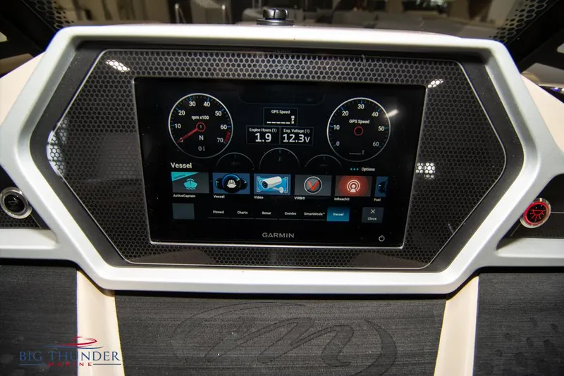 Slide: The Image of 2022 Manitou 25 Oasis SR SHP dashboard with Garmin display and controls. - 20