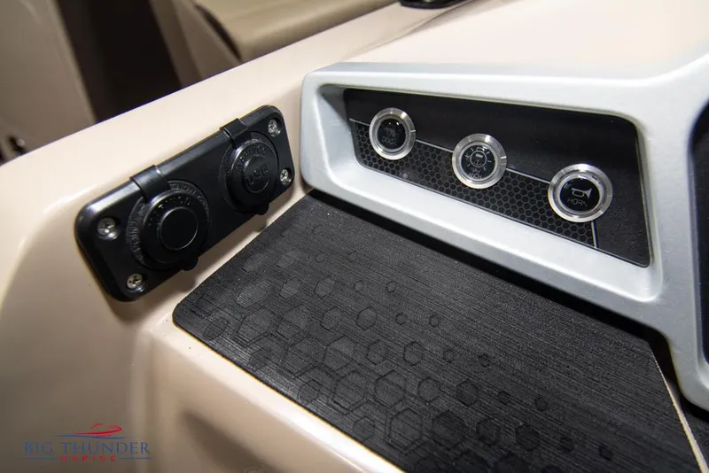 Slide: The Image of Control panel of 2022 Manitou 25 Oasis SR SHP boat with various switches and outlets. - 21