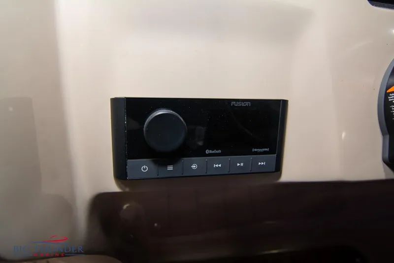 Slide: The Image of Fusion audio control panel on 2022 Manitou 25 Oasis SR SHP boat dashboard. - 24
