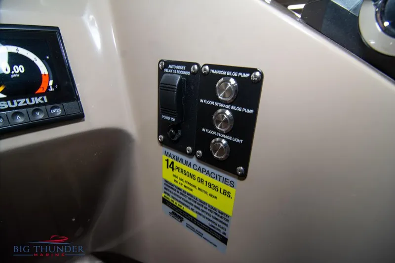 Slide: The Image of Control panel of a 2022 Manitou 25 Oasis SR SHP boat with capacity label. - 25