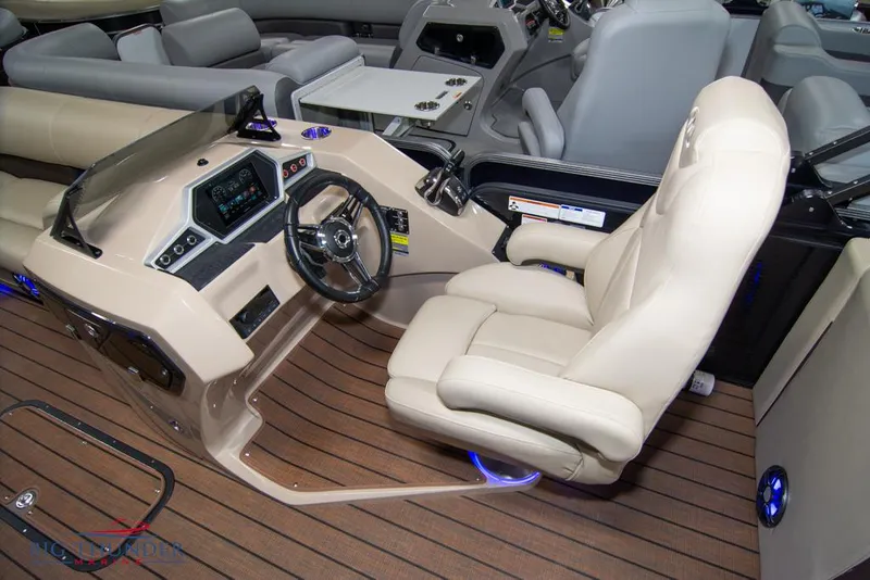 Slide: The Image of 2022 Manitou 25 Oasis SR SHP boat interior with captain's chair and control console. - 27