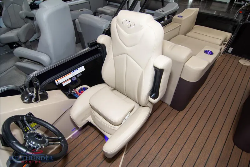 Slide: The Image of 2022 Manitou 25 Oasis SR SHP boat interior with captain's chair and steering wheel. - 29