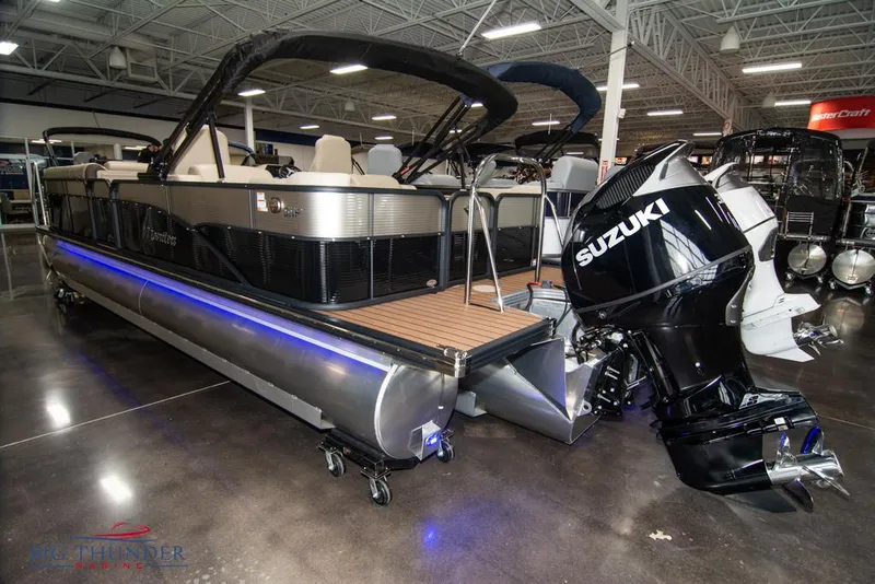Slide: The Image of 2022 Manitou 25 Oasis SR SHP pontoon boat with Suzuki outboard motor in showroom. - 3